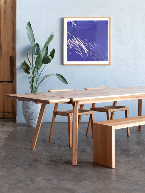 timber extendable dining table with plant