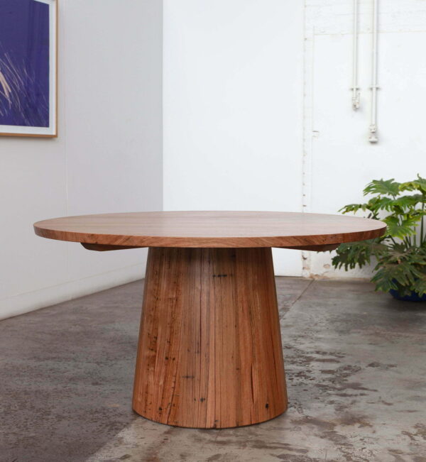 timber circular dining table with plants