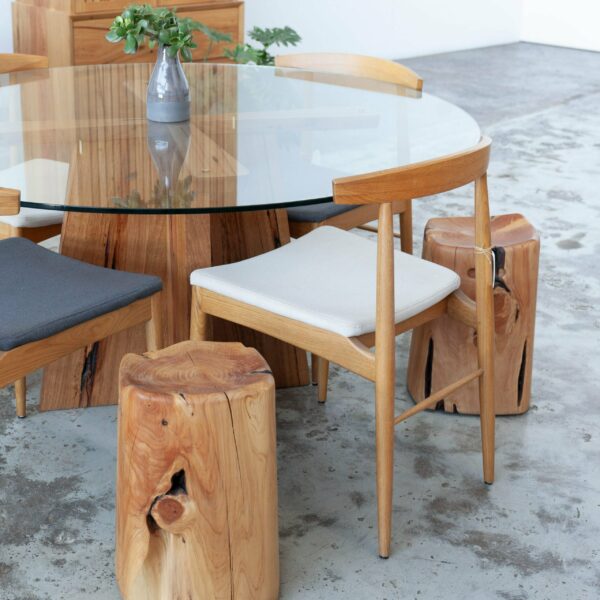Glass top timber dining table with dining chairs and stools
