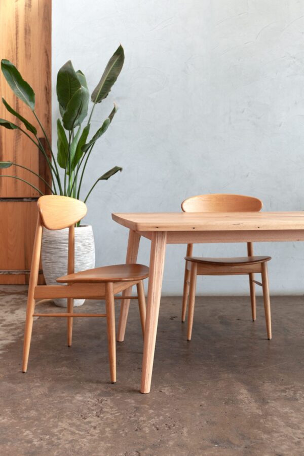 timber dining table with dining chairs and plants