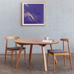 round timber dining table with dining chairs
