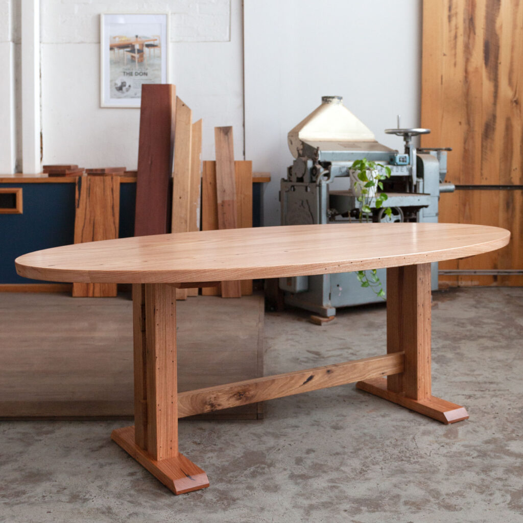 oval timber dining table with pedestal base